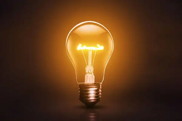 Yellow Light Bulb with a Dark Background