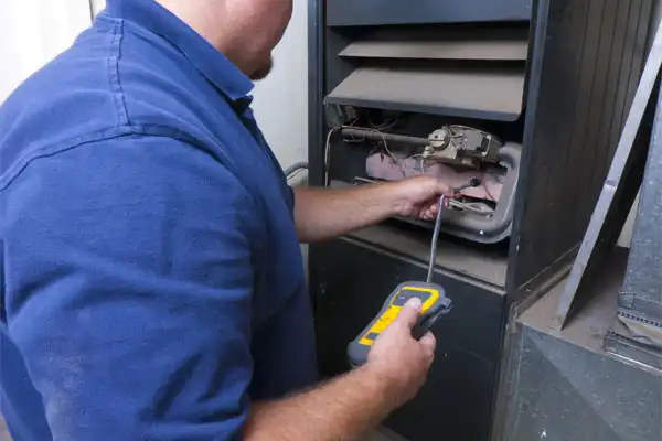 Technician working on HVAC unit